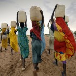 Women-Carrying-Water-On-Their-Heads